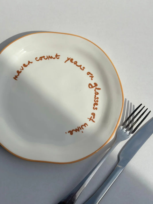 SLOGAN PLATE - "NEVER COUNT YEARS OR GLASSES OF WINE"